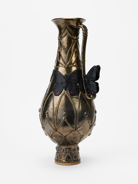 Brozed clay vessel with handle in the style of ancient middle eastern wine servers.